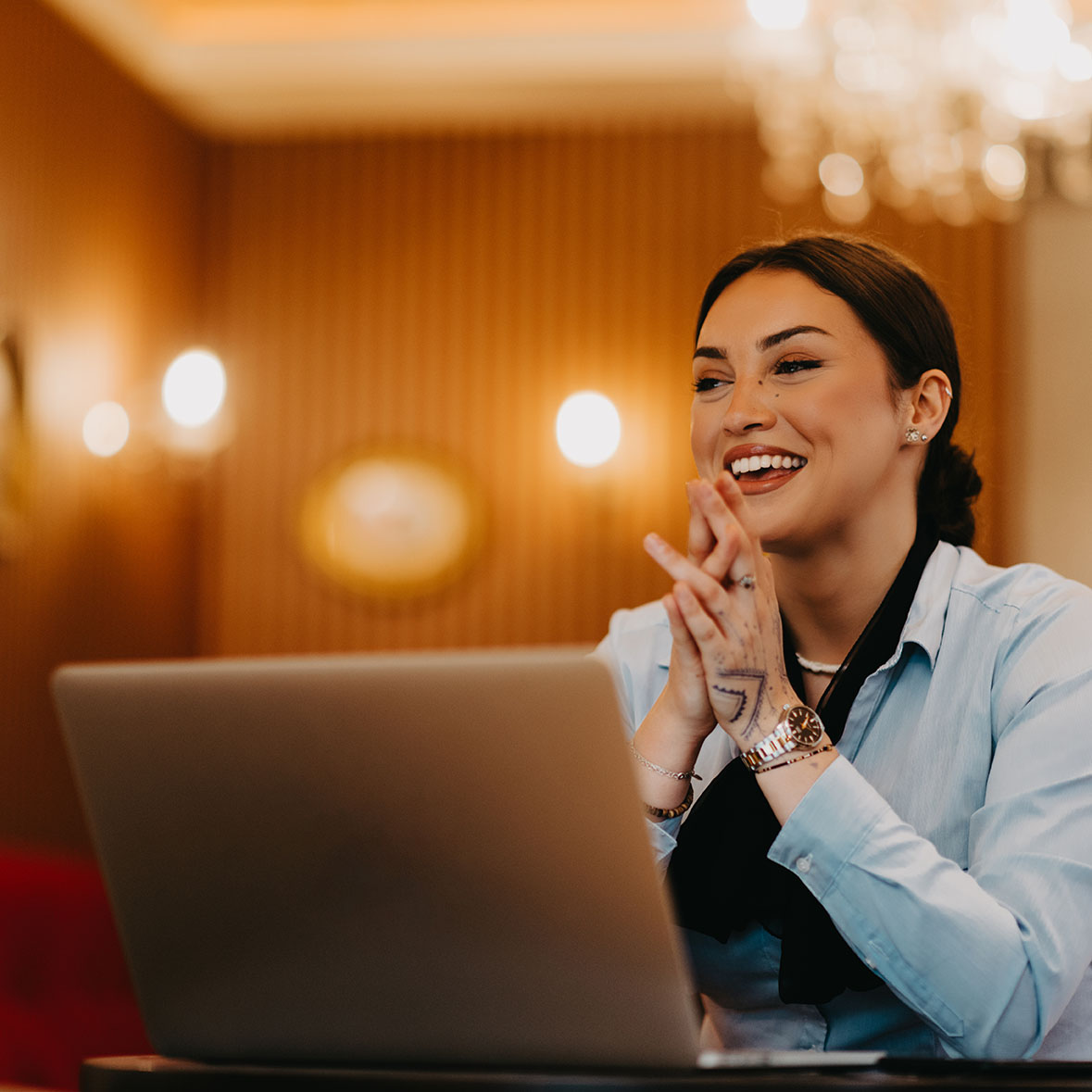 Radiant Latina businesswoman confidently leads business meeting over coffee.